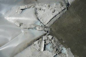 Vapor barrier between insulation of concrete slab.